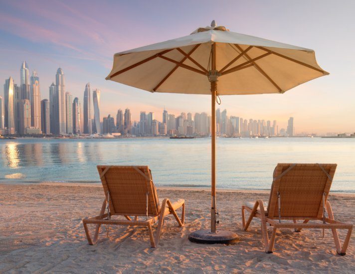 Beautiful terrace with two chairs and an umbrella with Dubai Marina view
