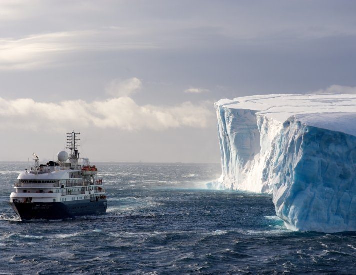 The cruise ship Corinthian II in front of a huge Iceberg in Antarctic Sound. Antarctic Sound is at the northern tip of the Antarctic Peninsular and connects the Southern Ocean to the Wedell Sea. Even in the summer months it is often filled with huge tabular icebergs